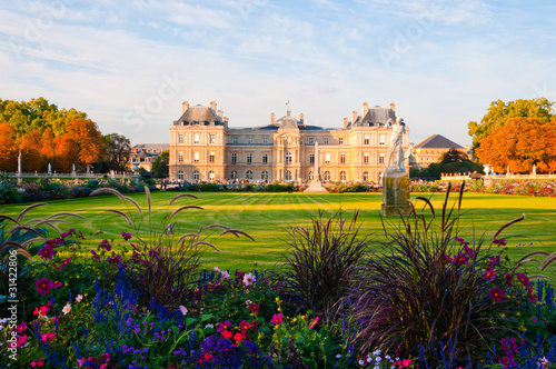 Jardin du Luxembourg with the Palace and statue. Few flowers are photo