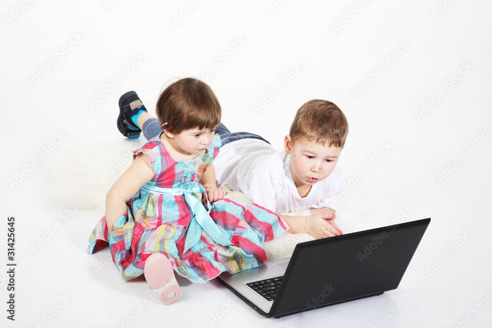 brother and the sister look cartoon films on a laptop brother and the sister look cartoon films on a laptop