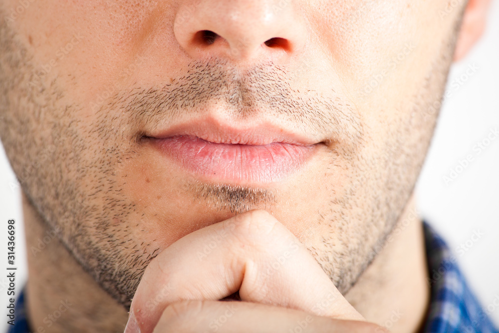 Closeup of a young thoughtful man's lips and chin Closeup of a young thoughtful man's lips and chin
