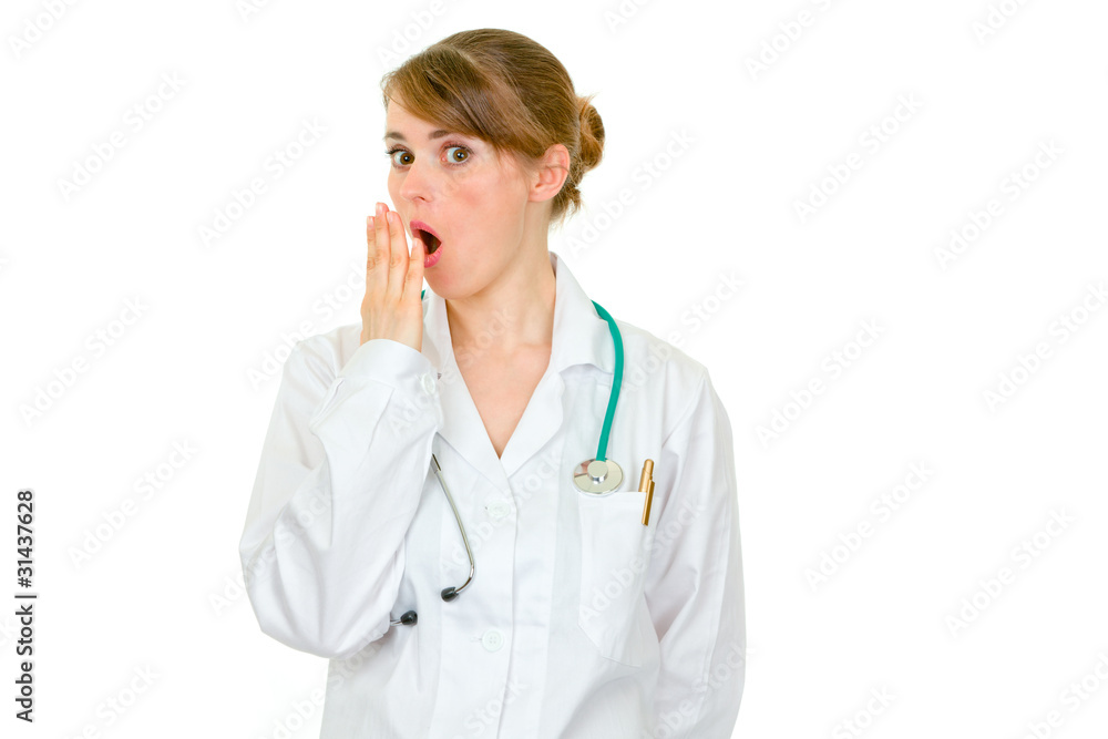 Shocked female medical doctor holding her hand near mouth Shocked female medical doctor holding her hand near mouth
