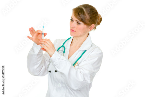 Concentrated doctor woman preparing to inoculate isolated