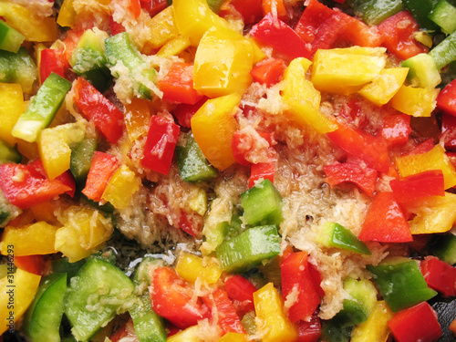 Yellow, red and green Bulgarian pepper in skillet.