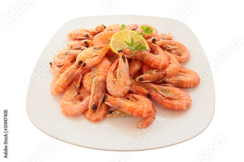Cooked shrimp on a large plate. Isolated on white