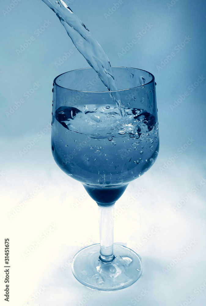 glass goblet in which the water flowing glass goblet in which the water flowing