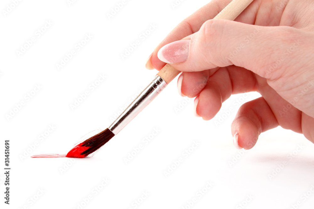 Paint brush in hand isolated on white Paint brush in hand isolated on white