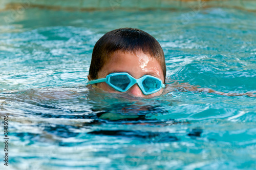 Kid submerging in the pool. © tomalu