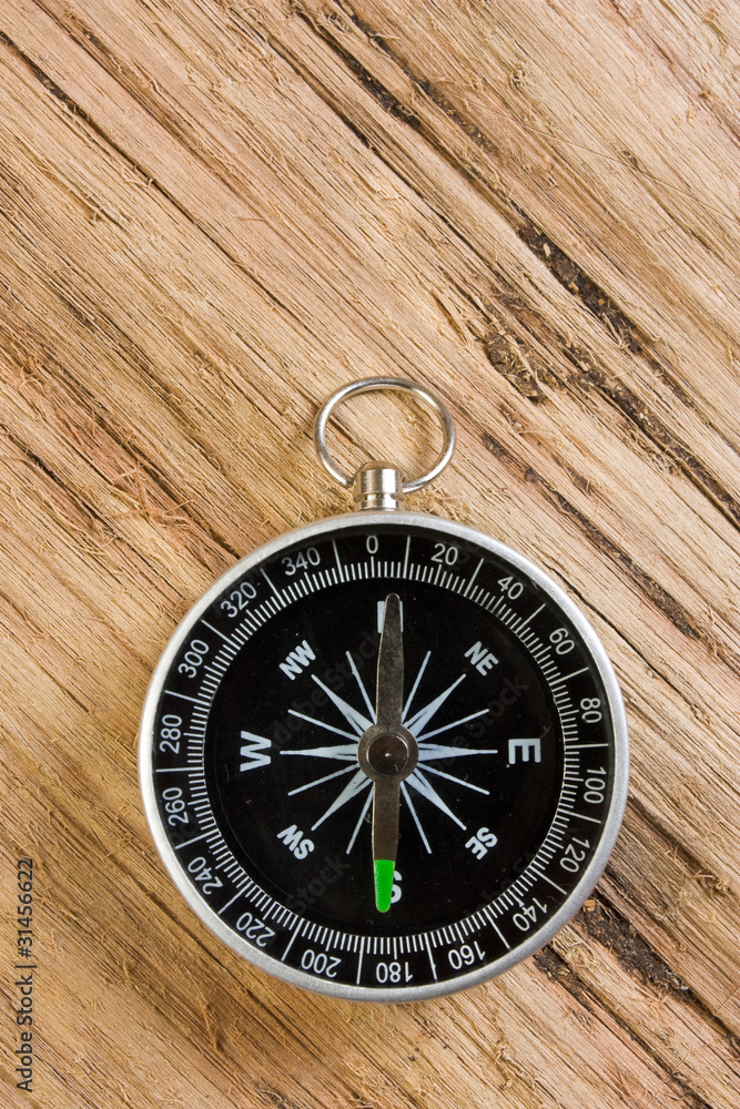 compass on the background of the wooden planks compass on the background of the wooden planks