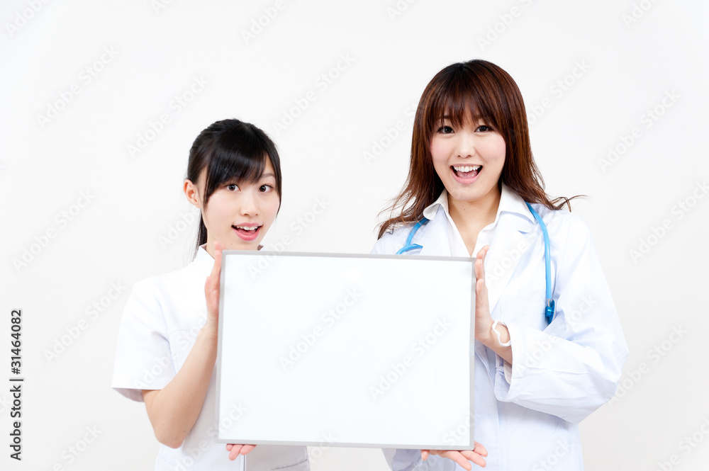 two asian beautiful doctor with blank whiteboard two asian beautiful doctor with blank whiteboard
