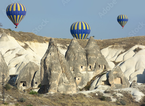 Balloon Over Rock Cave Houses, Cappadocia photo