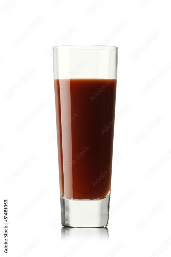 Fresh tomatoes and a glass full of tomato juice.