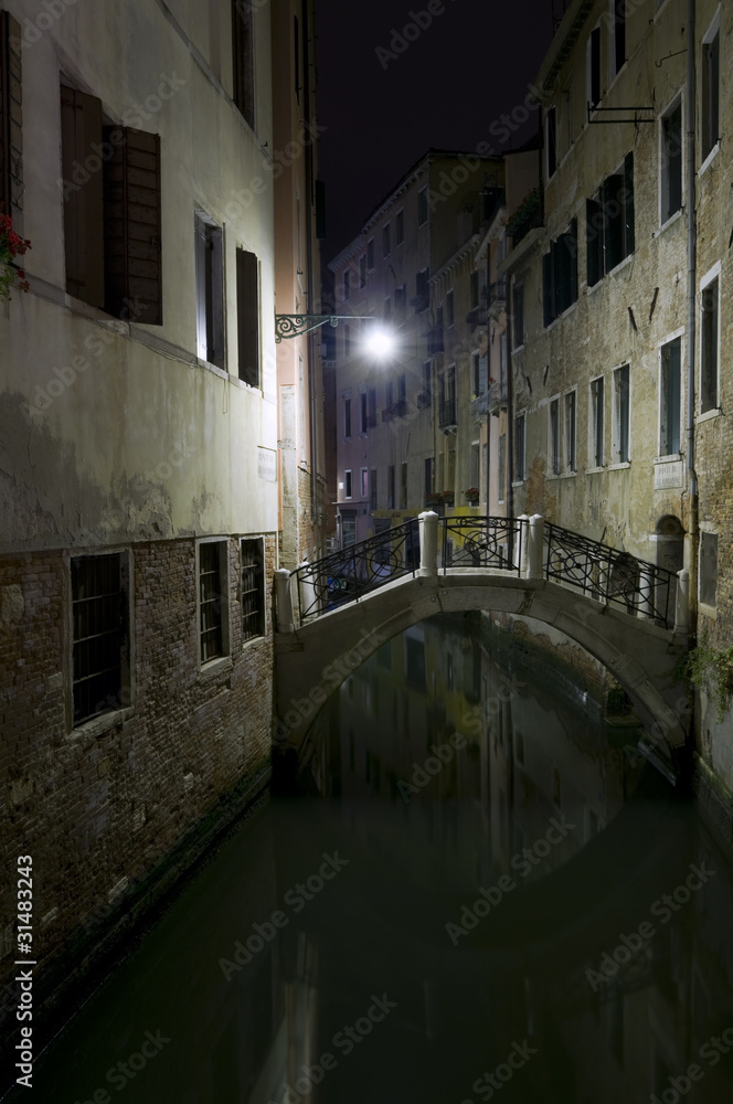 Little canal in Venice by night