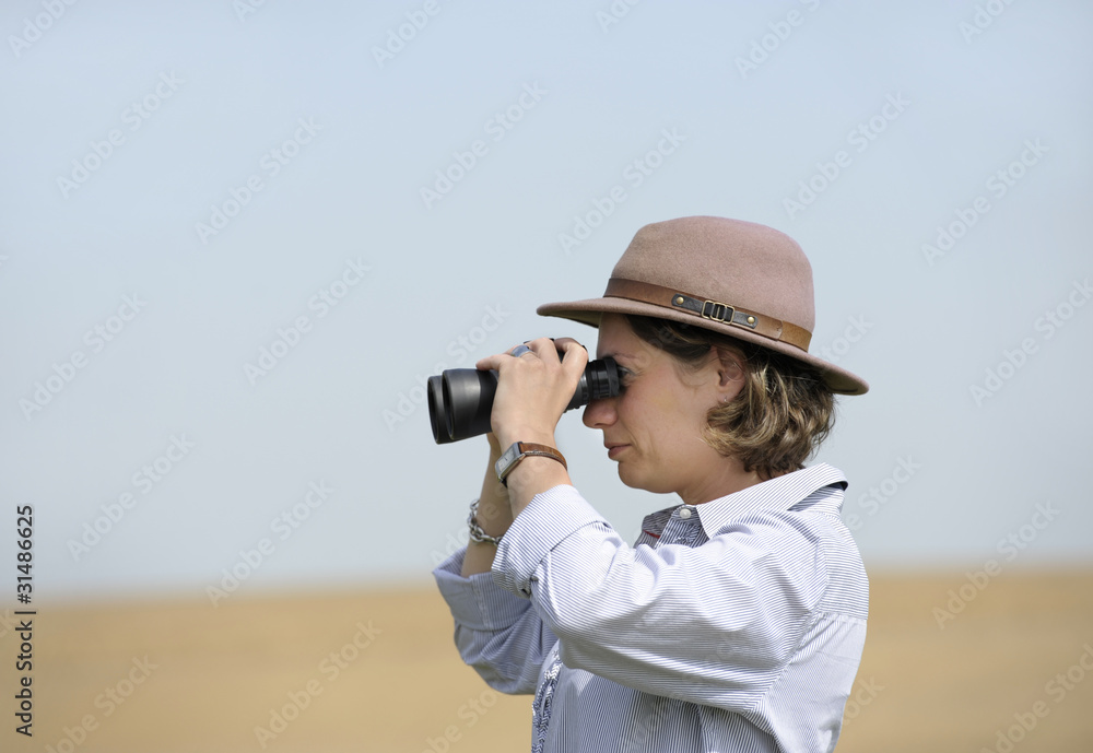 woman with binoculars outdoors
