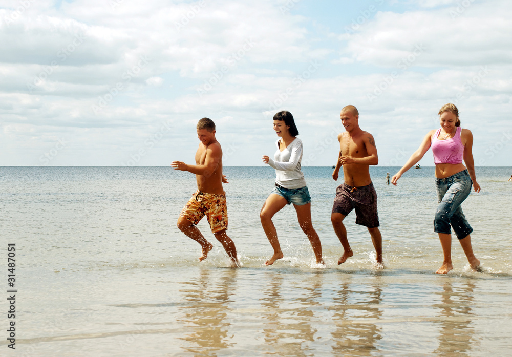 Group of friends having fun at the beach