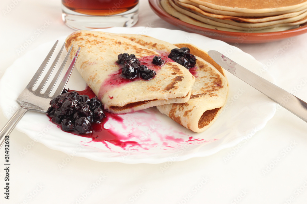 Pancakes on a plate with black current jam Pancakes on a plate with black current jam