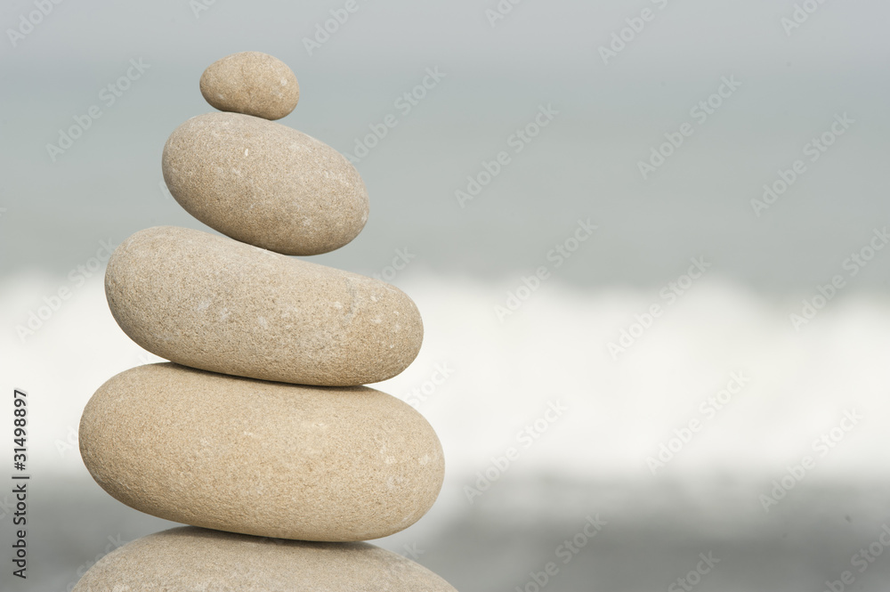 pile of balanced rocks against ocean background pile of balanced rocks against ocean background