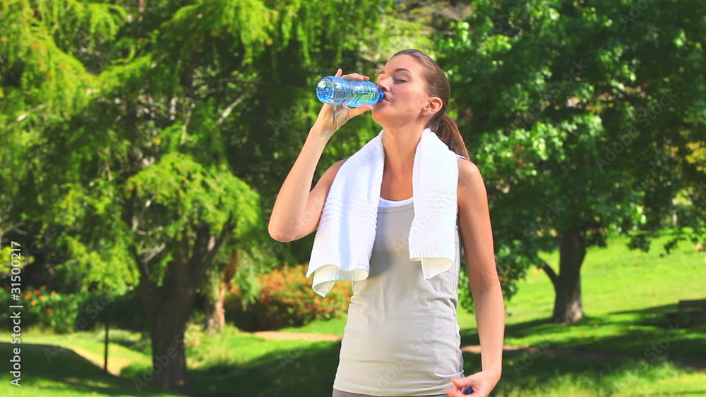 Woman drinking water after sports Woman drinking water after sports