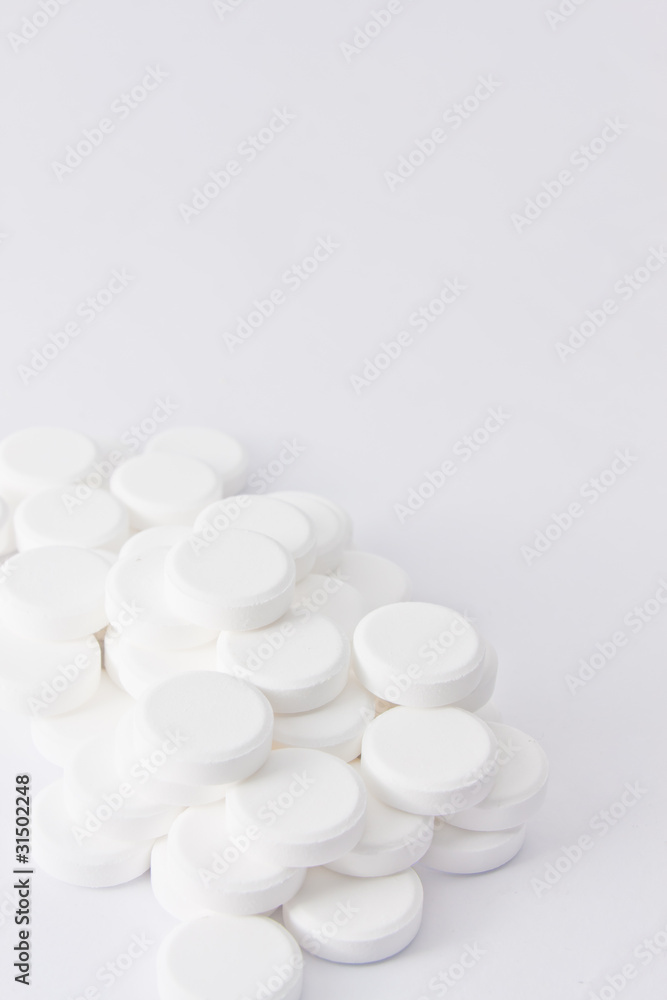 White pills on white background White pills on white background