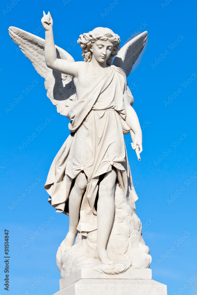 Marble statue of a young angel with a blue sky background Marble statue of a young angel with a blue sky background