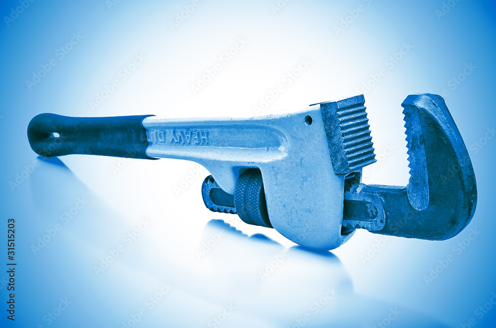 Monkey wrench in a blue background with reflections Monkey wrench in a blue background with reflections