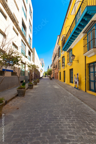 Typical street in Old Havana surrounded by ancient  buildings © kmiragaya