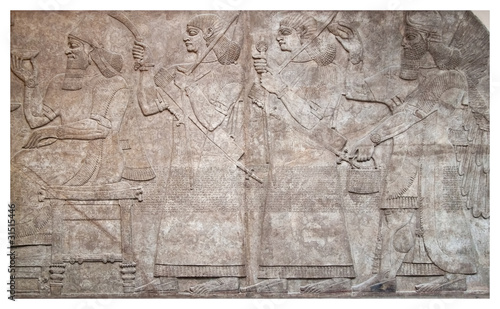 Ancient relief of assyrian winged gods and archers