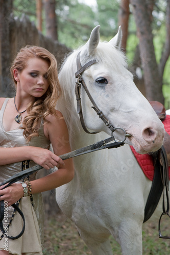 Rural pretty girl with a stallion