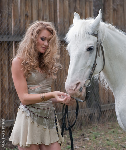Rural pretty girl with a stallion