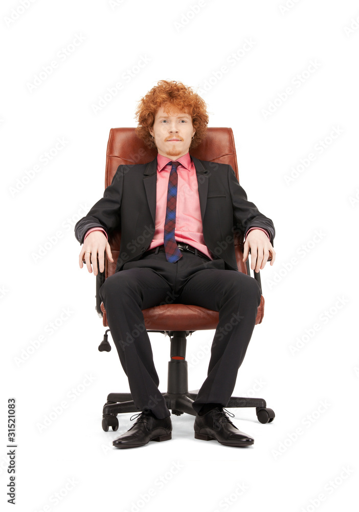 young businessman sitting in chair young businessman sitting in chair