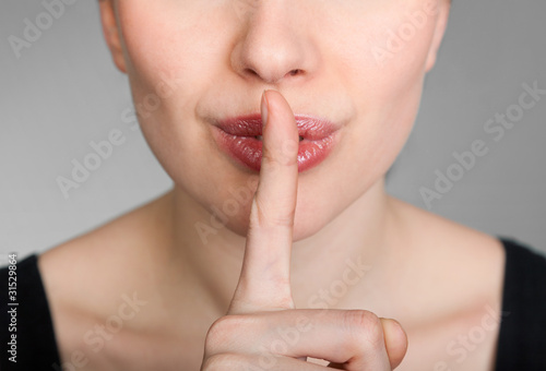 girl making a hush gesture