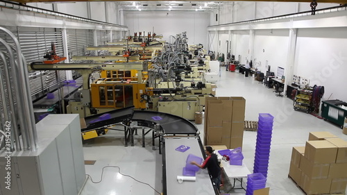 A wide shot time lapse of an entire robotics assembly plant in motion.
