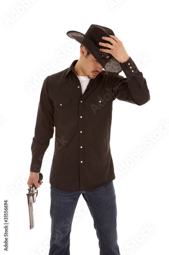 Cowboy holding hat and gun