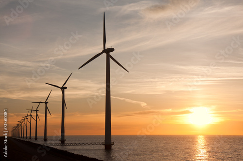 Wndturbines in the sea and a beautiful sunset