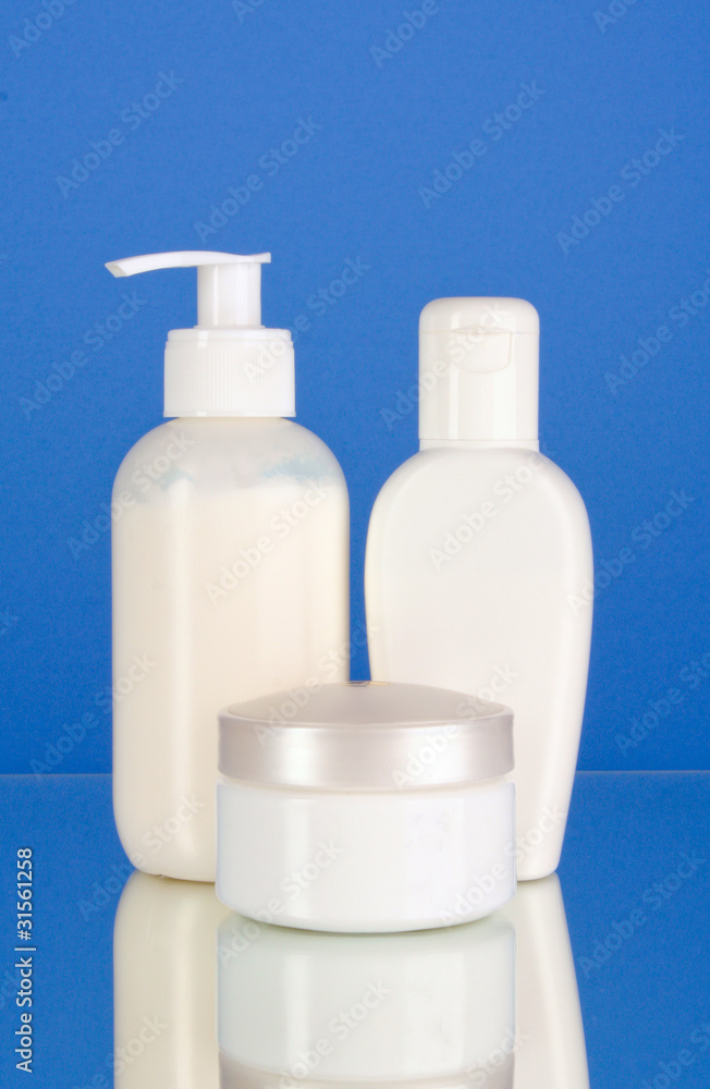 bottles of health and beauty products on blue background bottles of health and beauty products on blue background
