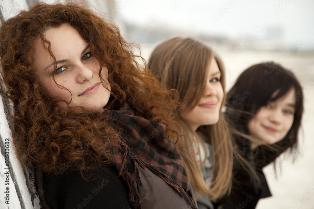 Fototapeta premium Three teen girlfriends at outdoor.