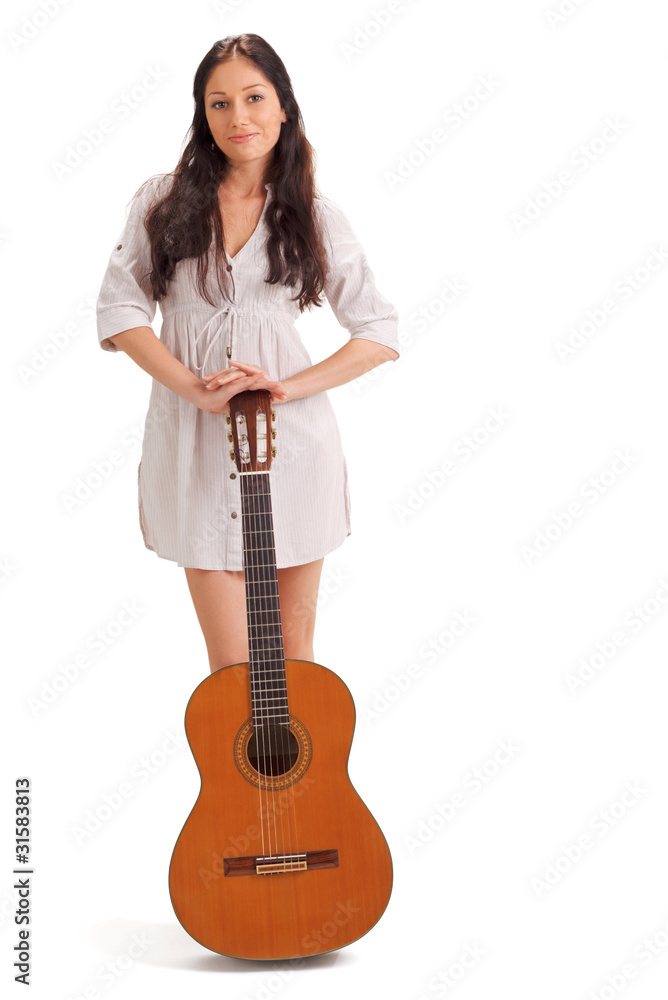 Young beautiful brunette lady in white chemise with acoustic gui Young beautiful brunette lady in white chemise with acoustic gui