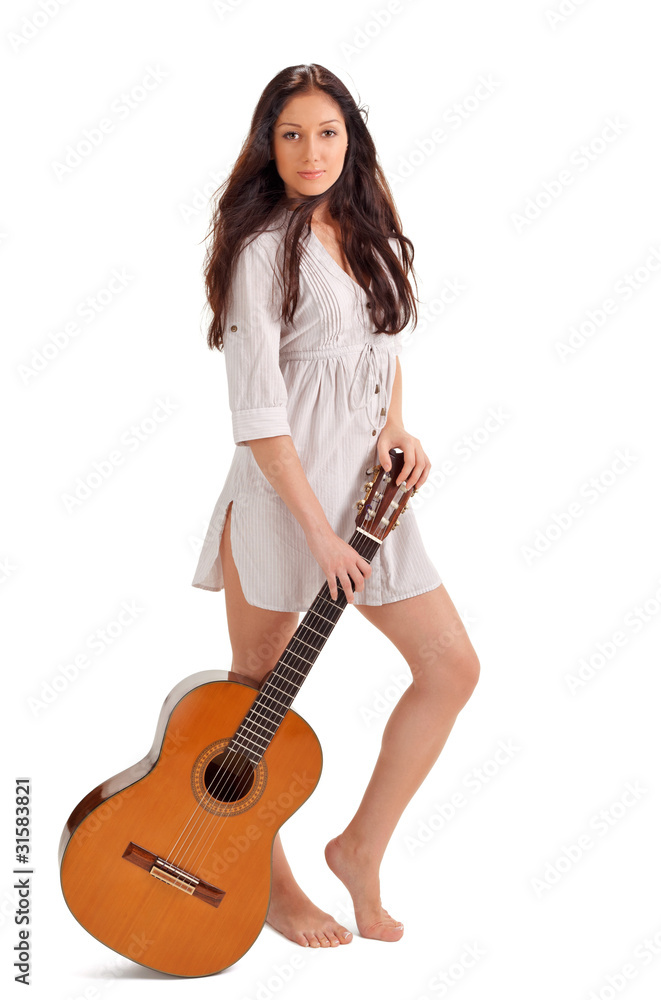 Young beautiful brunette lady in white chemise with acoustic gui Young beautiful brunette lady in white chemise with acoustic gui