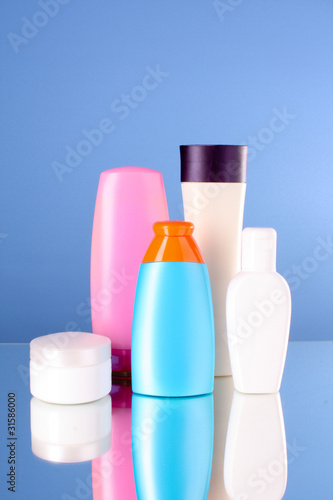 bottles of health and beauty products on blue background