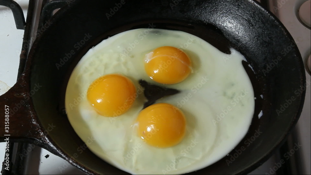 Fried eggs on black pan Fried eggs on black pan