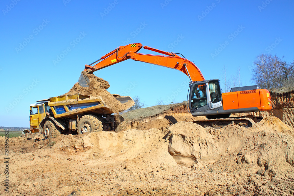 Obraz premium Backhoe loader loading dumper