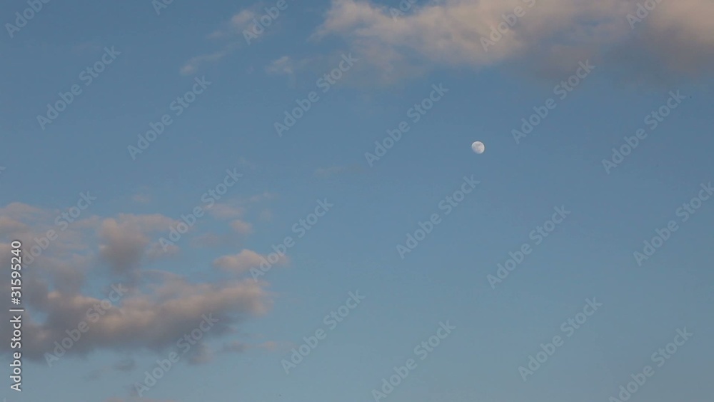 moon comes out from behind the clouds during the day moon comes out from behind the clouds during the day