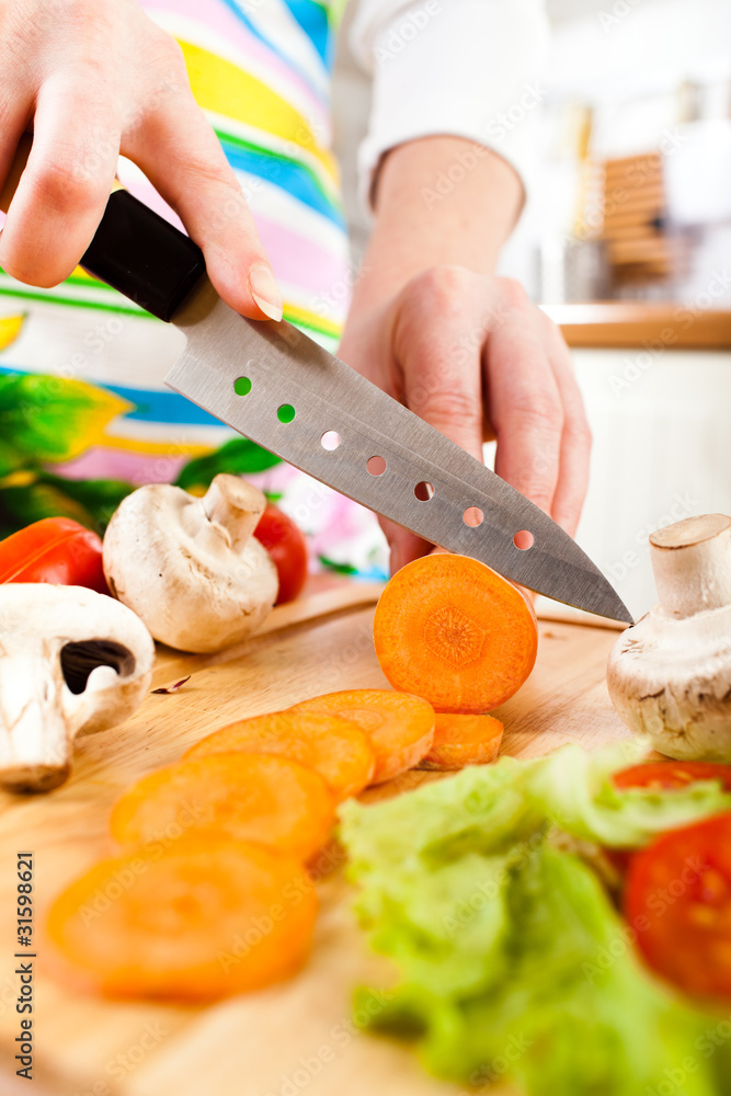 Woman's hands cutting vegetables Woman's hands cutting vegetables