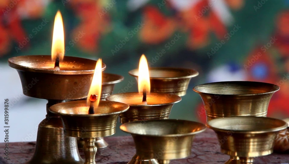 Burning oil lamps in a Buddhist monastery Burning oil lamps in a Buddhist monastery