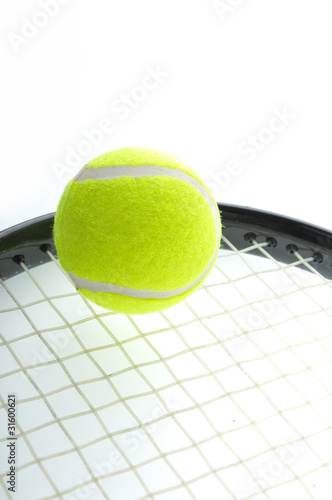 tennis ball on racket and isolated on white background.