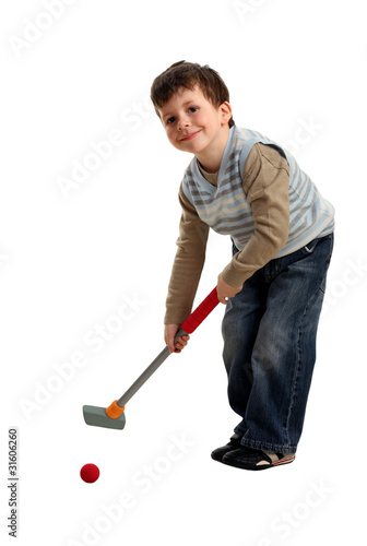 Happy boy preparing to hit a golf ball