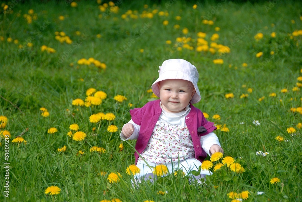 Cute child sitting within flowers Cute child sitting within flowers