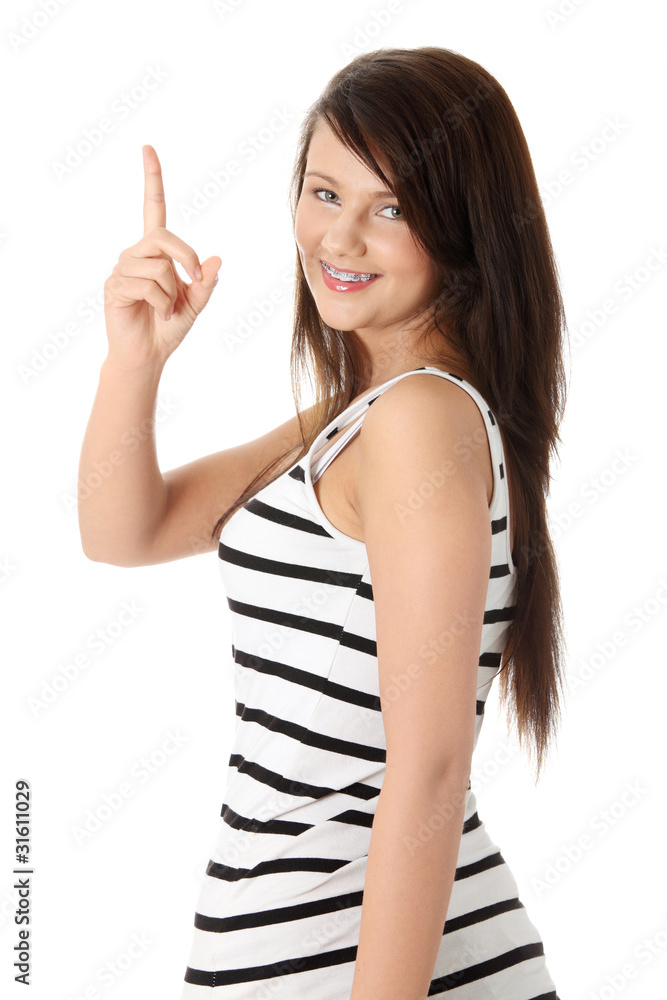 Young beautiful happy caucasian woman pointing up Young beautiful happy caucasian woman pointing up