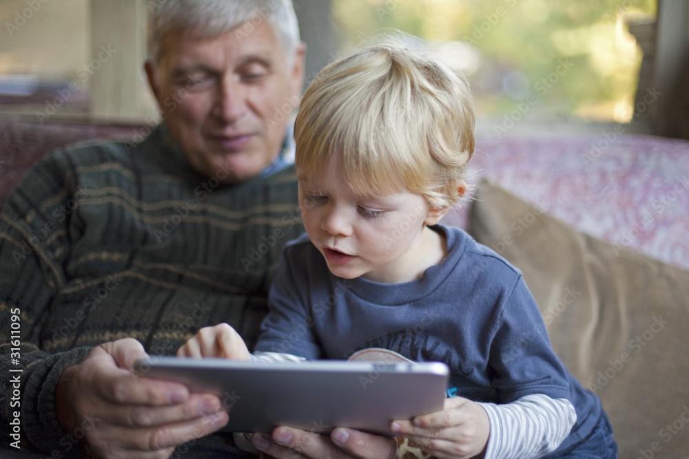 Grandfather and grandson using Tablet PC Grandfather and grandson using Tablet PC