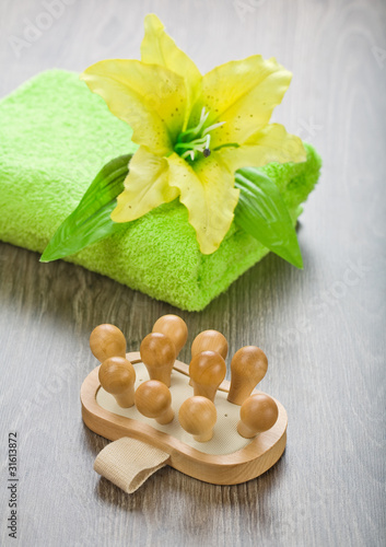 yellow flower on towel with massager