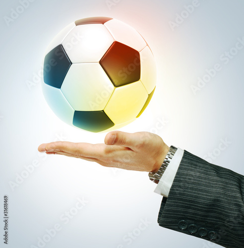 Single soccer ball on hend photo