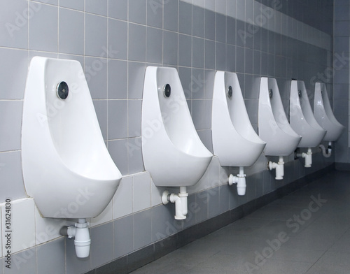 modern restroom interior with urinal row photo